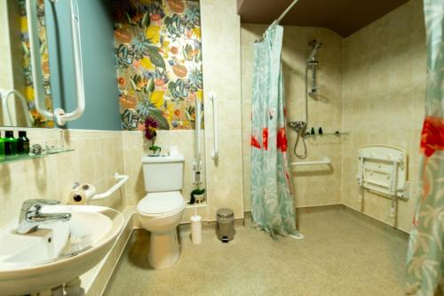 a bathroom with a toilet and a sink and a shower at Brockley Hall Hotel in Saltburn-by-the-Sea