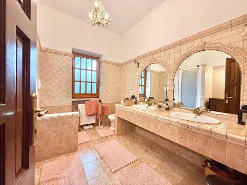 a bathroom with two sinks and a large mirror at La casa nel Bosco in Manziana