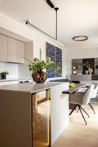 a kitchen with a island with a potted plant on it at Stylish Waterfront stay with Lounge Terrace & Sauna in Tallinn