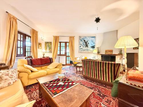 a living room with a couch and a table at La casa nel Bosco in Manziana