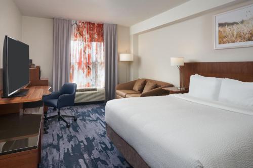 a hotel room with a bed and a desk and a television at Fairfield Inn & Suites by Marriott Orlando International Drive/Convention Center in Orlando