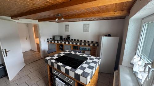a kitchen with a stove and a refrigerator at FeWo -schiefe- Marie in Oberlungwitz