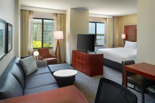 a hotel room with a bed and a couch at Residence Inn by Marriott National Harbor Washington, D.C. Area in National Harbor