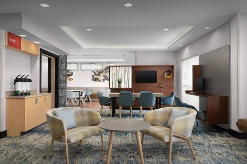 a conference room with a table and chairs and a kitchen at TownePlace Suites by Marriott Goldsboro in Goldsboro