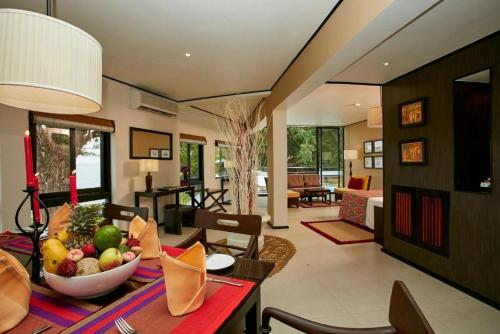 a living room with a table with a bowl of fruit at EKHO Safari Tissa in Tissamaharama