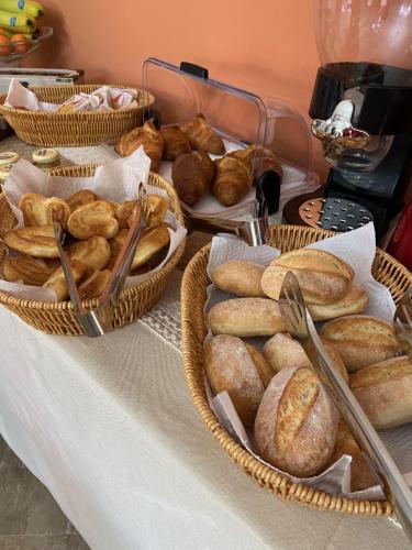a table with baskets of bread on it at Villa Rita Guest House Torvaianica in Torvaianica