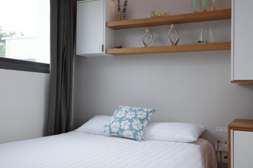 a small bedroom with a bed and a window at Aewol Bada 23 in Jeju