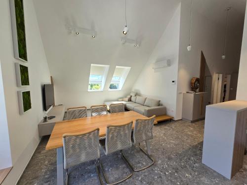 a living room with a table and chairs and a couch at Alpine Haven in Bovec