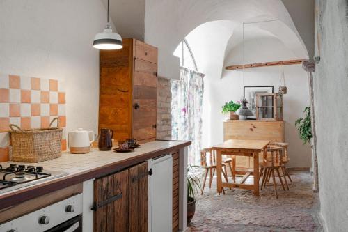 a kitchen with a counter and a table in a room at JAR - Apartments in Castion Veronese