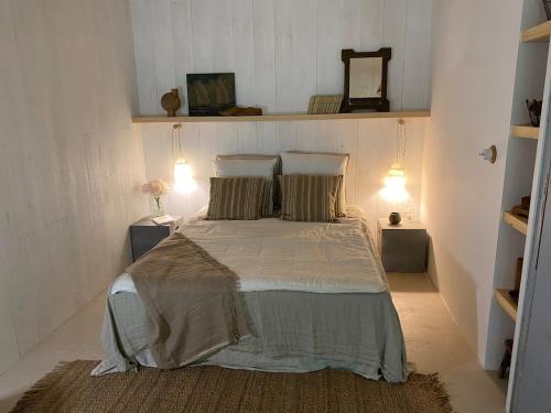 une chambre avec un lit avec deux oreillers dans l'établissement La cabane dans les arbres, à Couze-et-Saint-Front