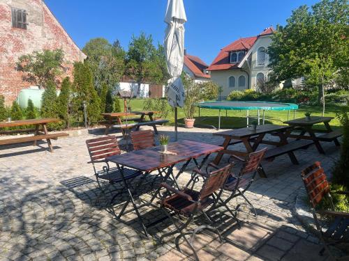 a patio with tables and chairs and an umbrella at Landgasthof - Hotel zum Stern in Linden