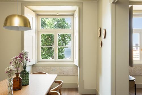 a dining room with a table and a window at Hermitage Castelo - Casa Sé in Lisbon