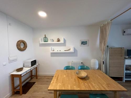 a dining room with a wooden table and chairs at Biniforcat CB 24 Bonito apartamento junto al mar in Cala en Forcat