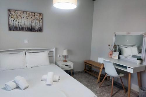 a bedroom with a bed and a desk and a mirror at Nikis House in Keramoti