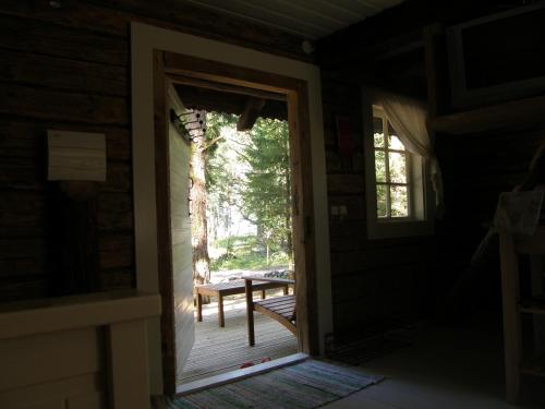 an open door to a porch with a bench outside at Ranna Villa Farm in Küdema