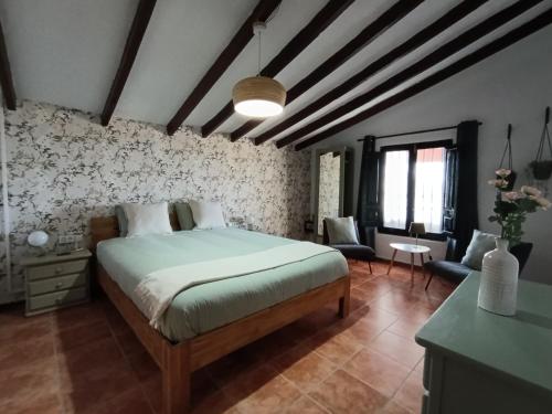 a bedroom with a large bed in a room at CasaArabí in Arabí