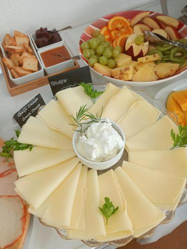 a table topped with cheese and a plate of appetizers at Casa João Chagas Guesthouse, Constância, By Viva a Vida - Alojamentos e Hotels in Constância