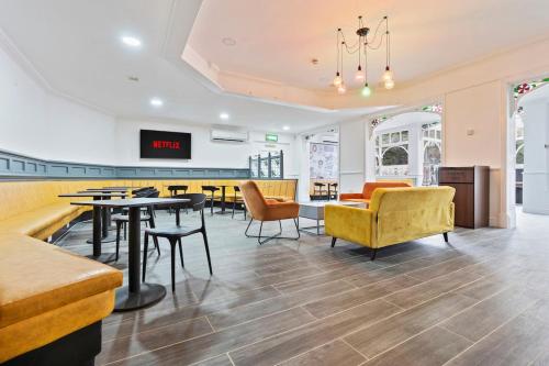 a waiting room with tables and chairs in a store at Central Dudley Stay-Sleeps 3, Kitchen&Free Parking in Dudley