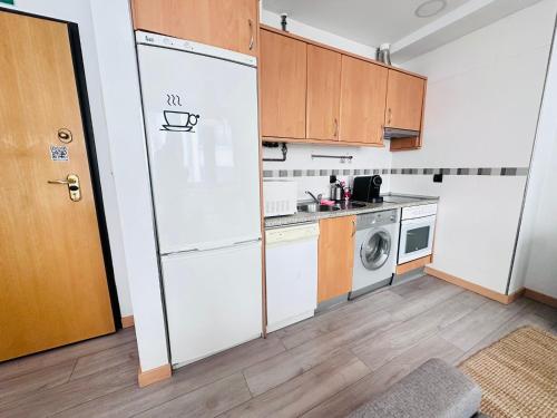 a kitchen with a refrigerator and a washer and dryer at Atuaire Home En la Plaza Mayor de Burgos Parking Incluido in Burgos