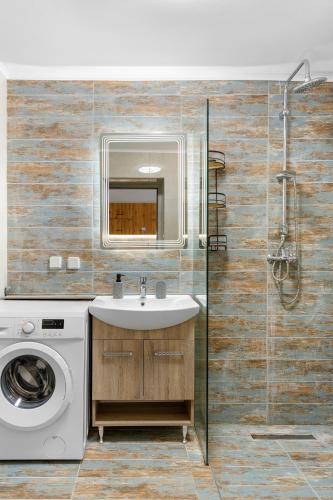 a bathroom with a sink and a washing machine at VaSteka House 2 in Haraki