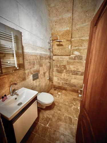 a bathroom with a white toilet and a sink at Evra Cappadocia Hotel in Nevşehir