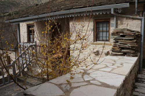 a stone house with a tree in front of it at The Mountain House -mountain getaway in Sirako