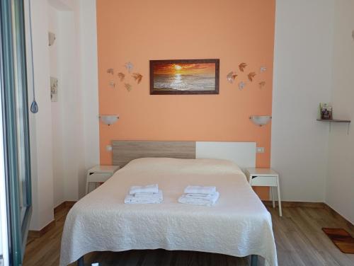 a bedroom with a bed with two towels on it at B&B da AnnaMaria in Maratea