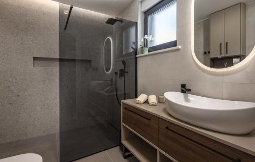 a bathroom with a sink and a glass shower at Villa Aura by Villas Guide in Urinj