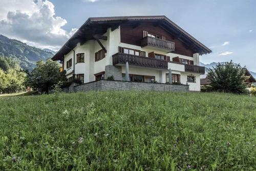 a house on top of a hill with a green field at Landhaus Schneider in Schruns-Tschagguns
