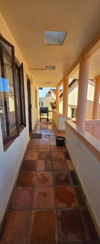 an empty hallway of a building with a table at Aloe Self Catering in Port Shepstone