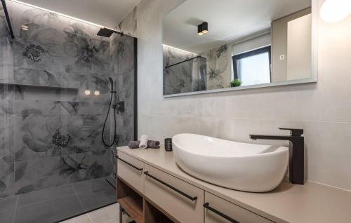 a bathroom with a white sink and a shower at Villa Aris by Villas Guide in Urinj