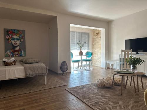 a living room with a bed and a table at La Vista by Ronda in Eforie Sud