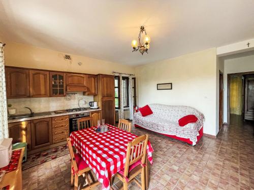 a kitchen with a table and a bed in a room at Apartment Cà Maria-1 by Interhome in Asti