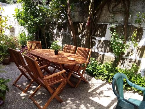 a wooden table with four chairs around it at Metro Casa Música Apartments and Rooms in Porto