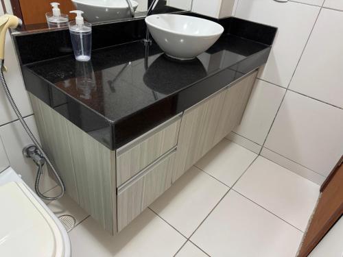 a bathroom with a sink and a toilet at Cobertura com Piscina no Iloa in Barra de São Miguel