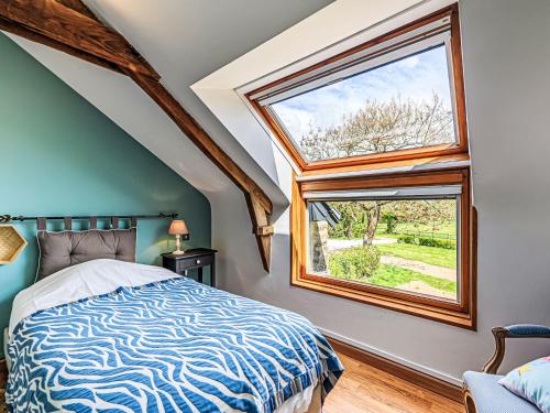 a bedroom with a bed and a large window at Holiday Home Karvez by Interhome in Ploeren