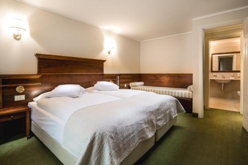 Postel nebo postele na pokoji v ubytování Hotel Reine Victoria