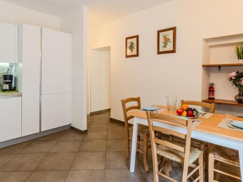 a kitchen and dining room with a table and chairs at Apartment Tre Laghi by Interhome in Carlazzo