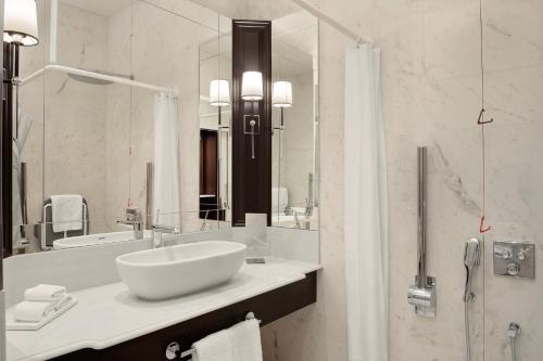 a bathroom with a sink and a large mirror at Fairmont Windsor Park in Windsor