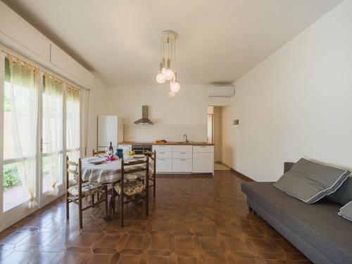 a kitchen and living room with a table and a couch at Apartment appartamento Stipeto by Interhome in Marina di Pietrasanta
