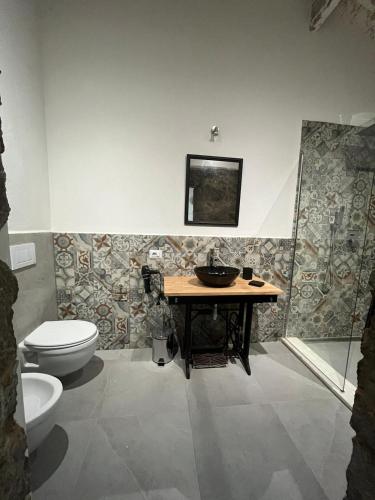 a bathroom with a sink and a toilet at B&B Salaju in Castelsardo