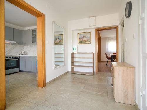 a kitchen with white cabinets and a table in it at Holiday Home Golub by Interhome in Duga Resa