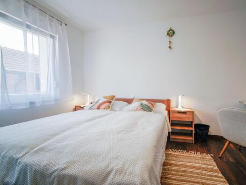 a bedroom with a large bed and a window at Holiday Home Golub by Interhome in Duga Resa