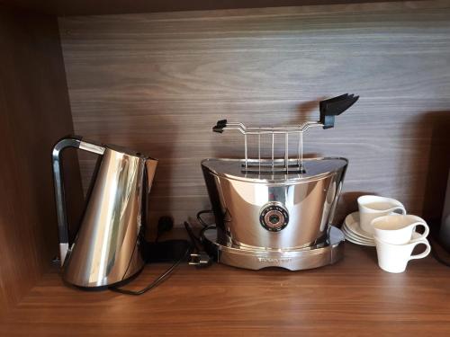 a food processor sitting on top of a counter with cups at Schafberg Luxury Apartment in St. Wolfgang