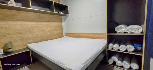 a small room with a bed in a closet at Sak Mobile Home Pirovac III in Pirovac