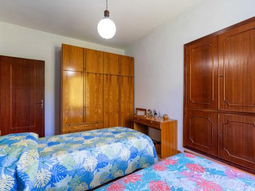 a bedroom with a bed and wooden cabinets at Apartment -2 by Interhome in Valloria