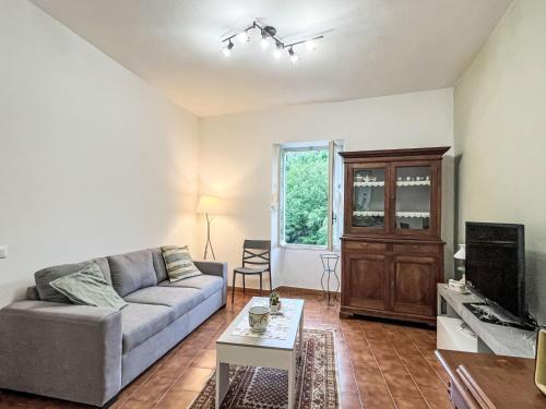 a living room with a couch and a tv at Apartment -2 by Interhome in Valloria