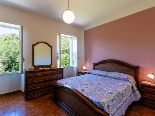 a bedroom with a bed and a mirror and a dresser at Apartment -2 by Interhome in Valloria