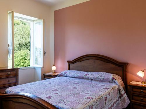 a bedroom with a bed and a window at Apartment -2 by Interhome in Valloria