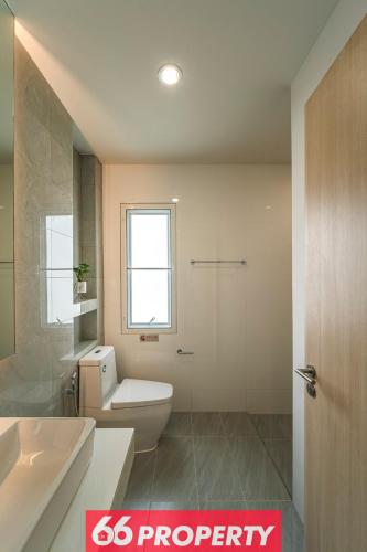 a bathroom with a white toilet and a sink at Modern 4 BR Home - Walk to Shopping and Supermarket in Chiang Mai